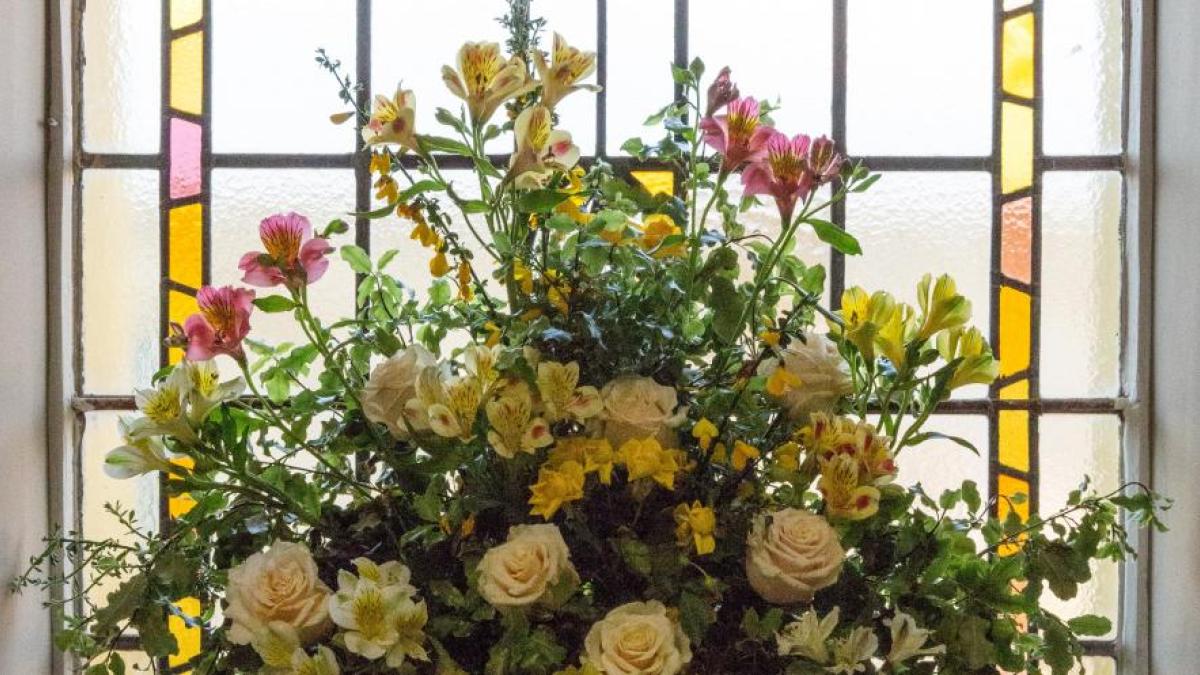 Flowers at stained glass window